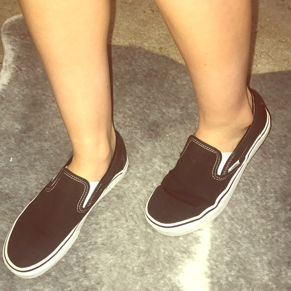 black slip on vans on feet